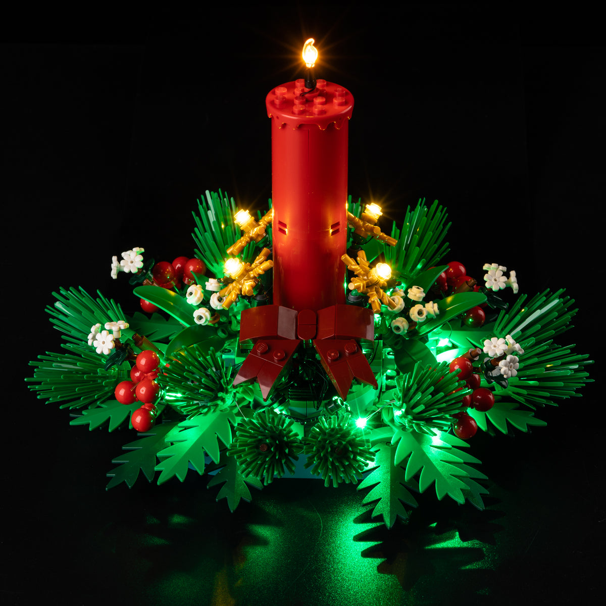Real Shopify front view of LEGO® Christmas Table Decoration 40743 with the warm candle LED, golden ornaments and green foliage lights on.