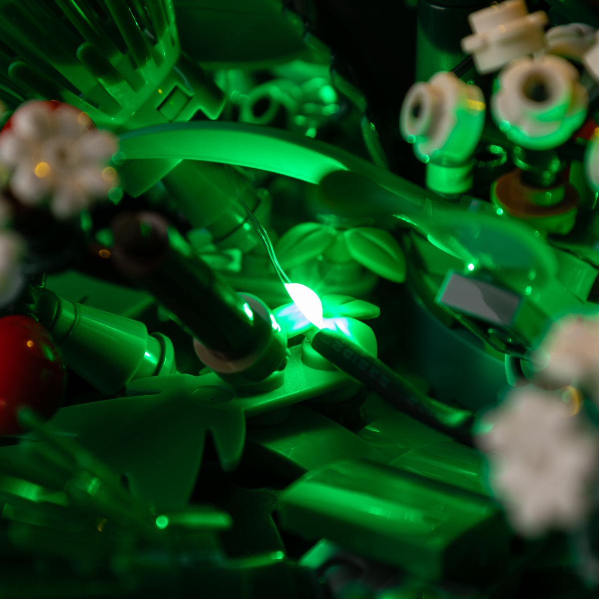 Real green LED points and local light spill among the layered LEGO® foliage of Christmas Table Decoration 40743.