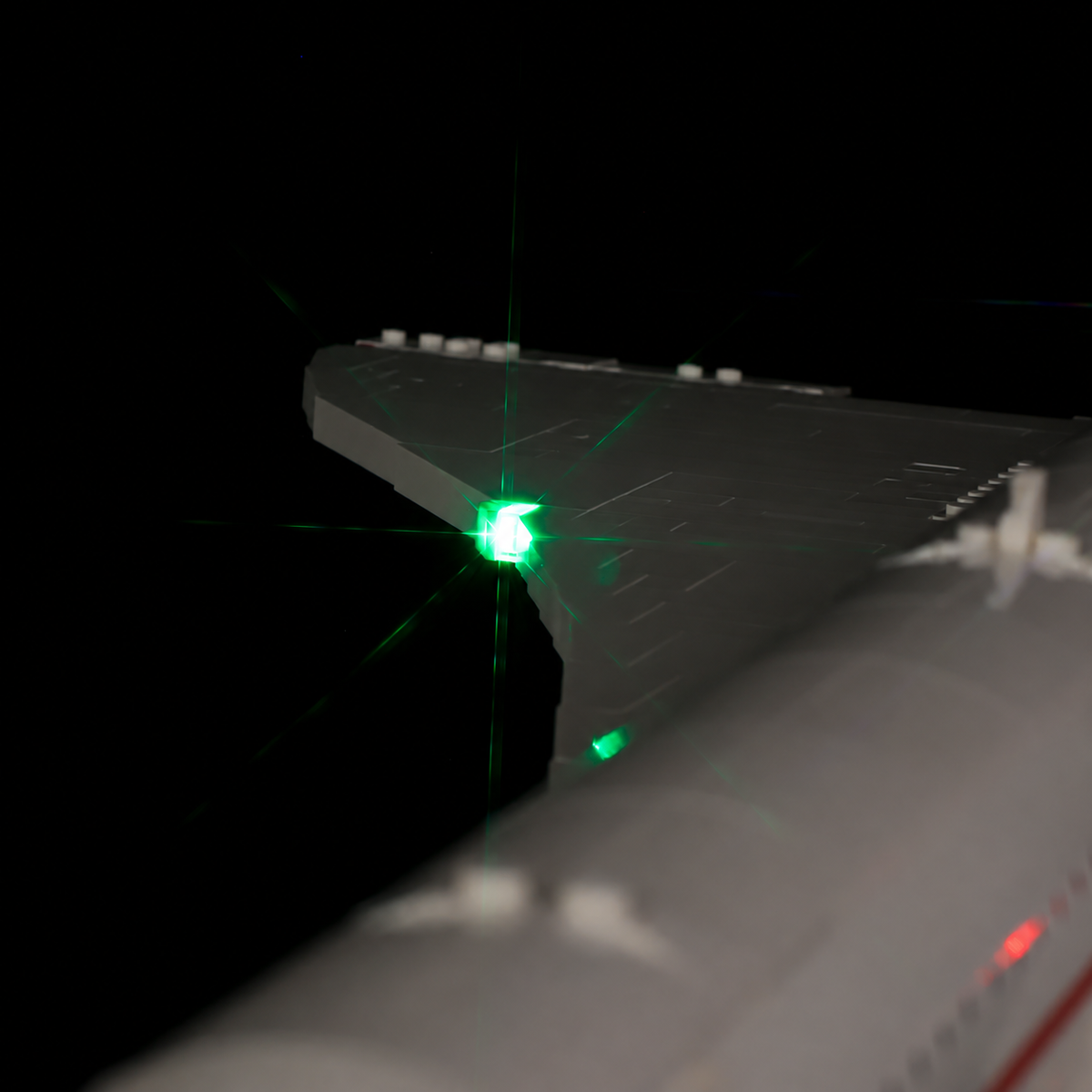 Close-up of the existing green navigation light and white LEGO bricks on the Concorde wing.