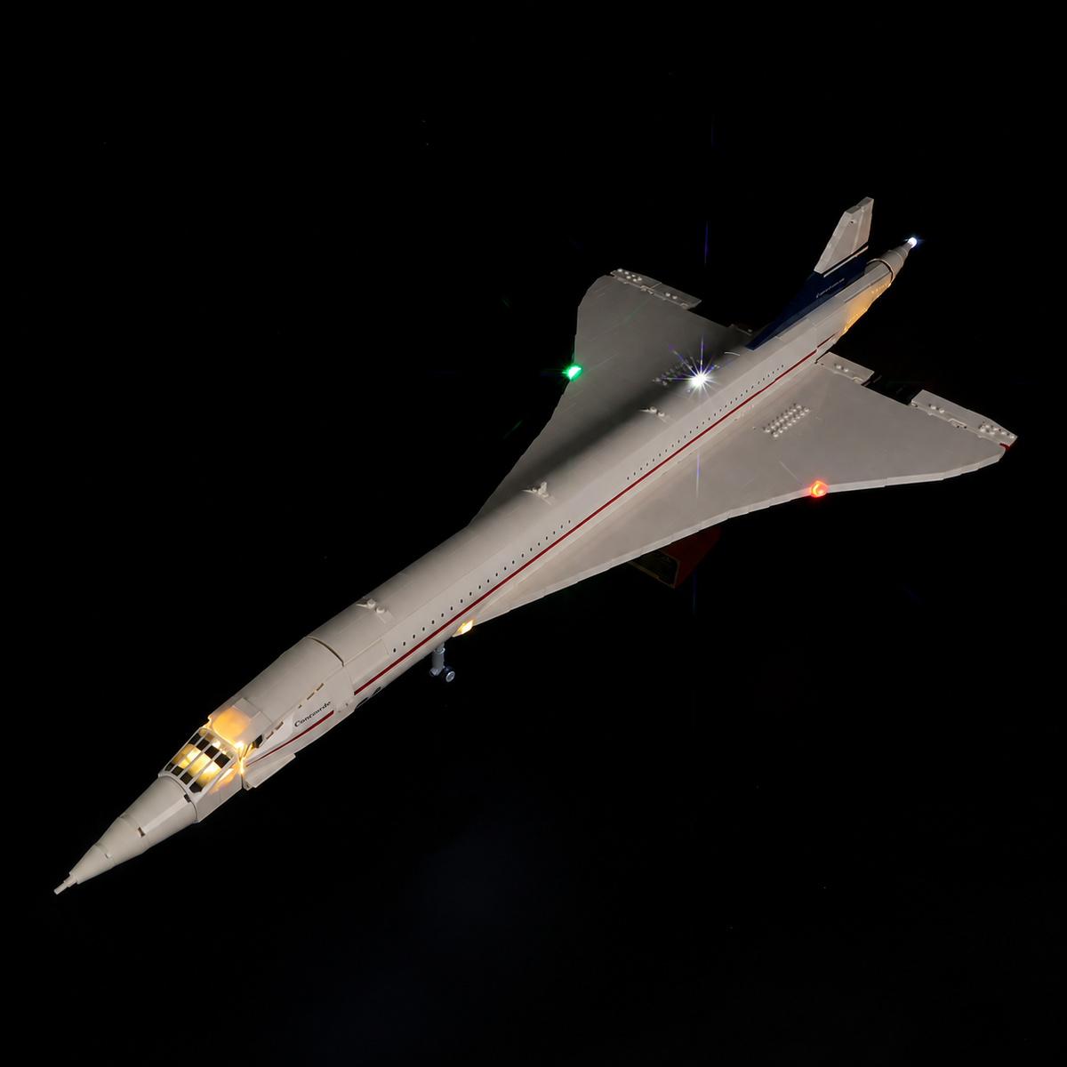 Elevated view of the illuminated LEGO Concorde showing its delta wings and actual red, green and white kit lights.