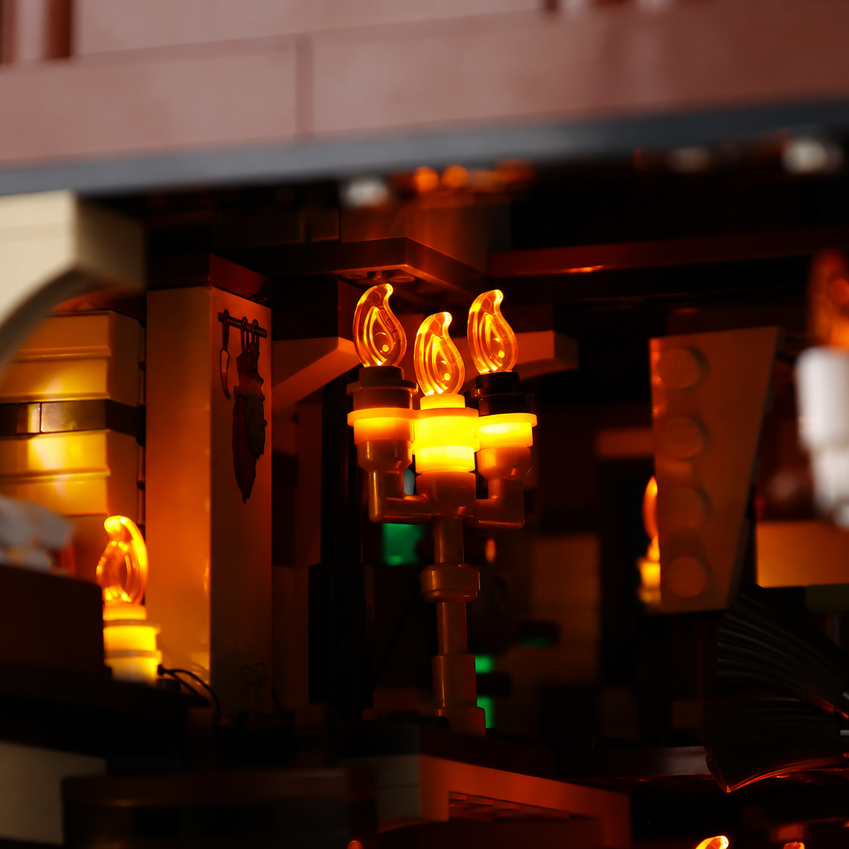 Warmly lit candleholder with translucent flames beneath the beams inside LEGO Disney Hocus Pocus: The Sanderson Sisters’ Cottage 21341