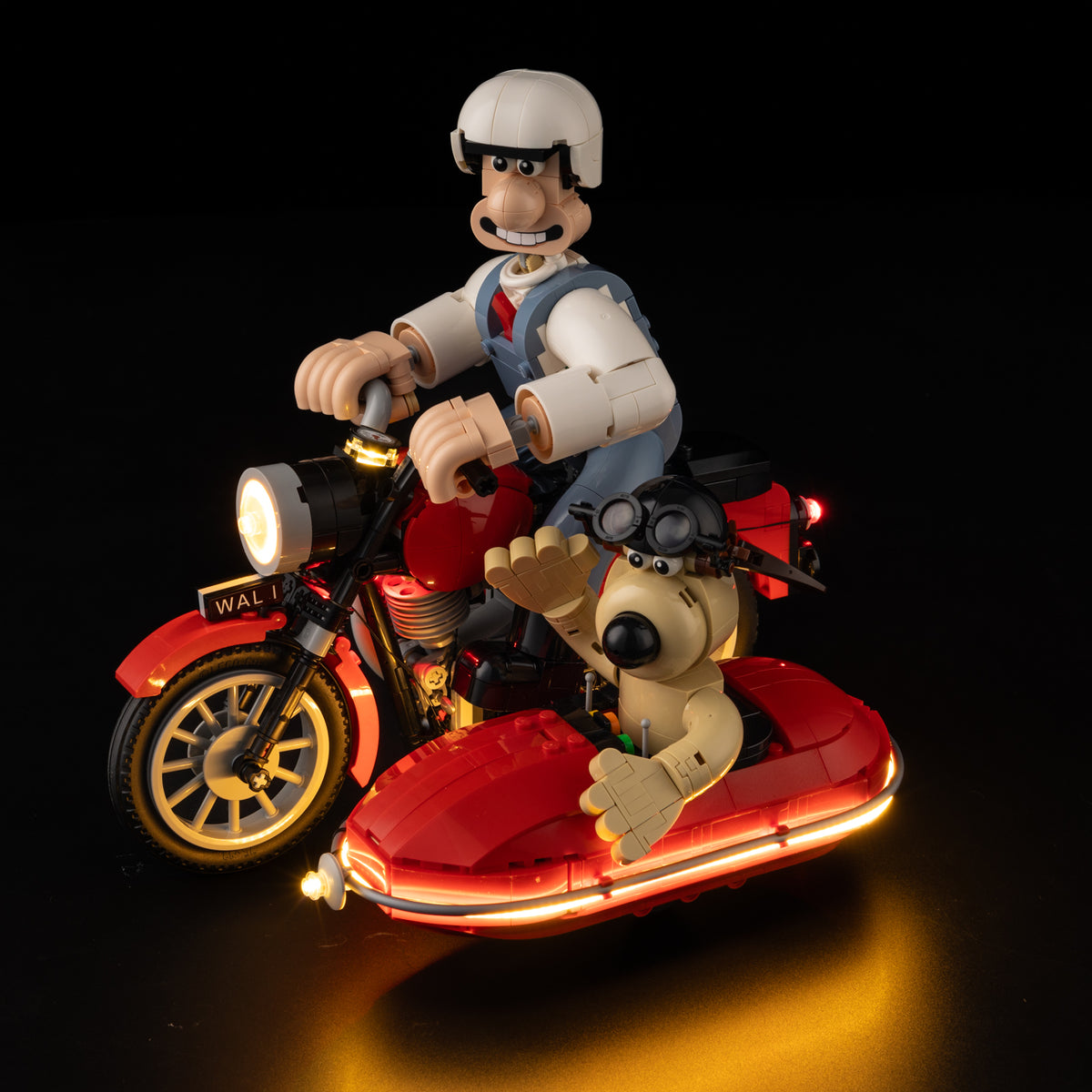 Real front-quarter Shopify photograph of LEGO® Wallace & Gromit 21371 with the Game of Bricks lights on.