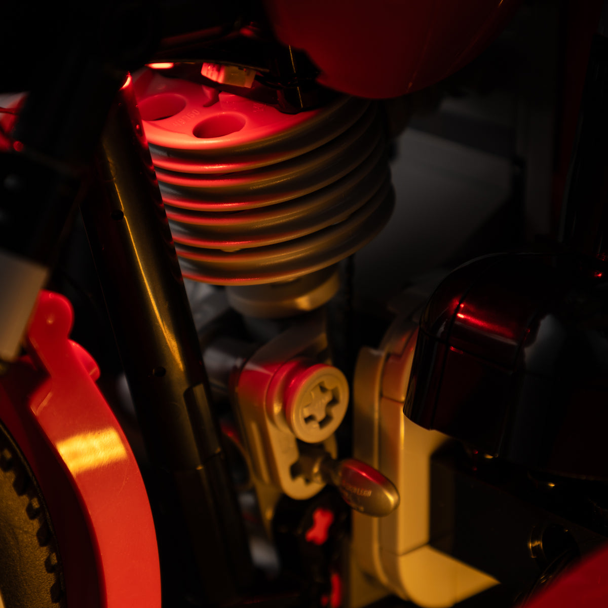 Actual red and amber kit lighting around the brick-built engine details of LEGO® Wallace & Gromit 21371.