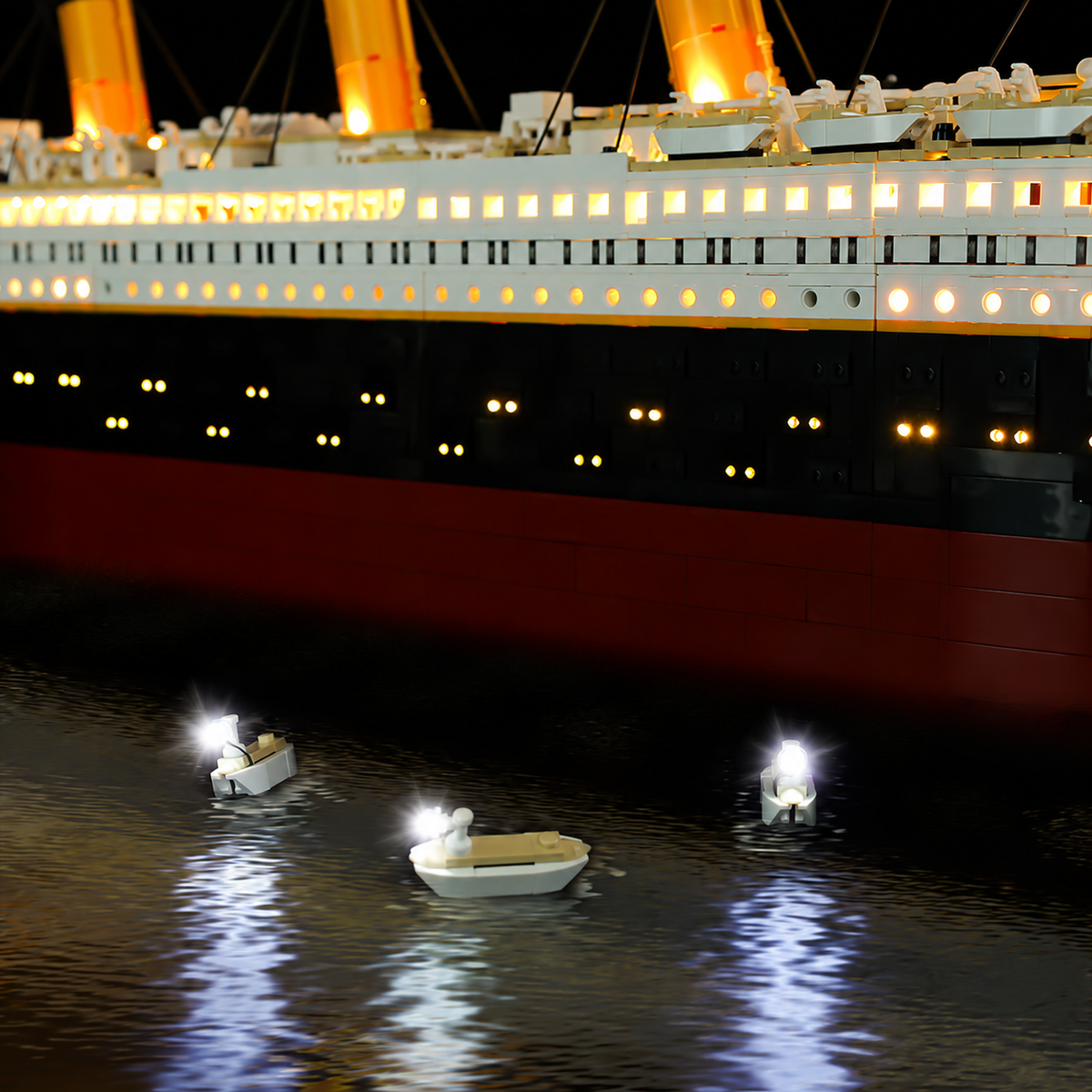 Illuminated portholes in the black hull of LEGO® Titanic 10294 with Enhanced lights.