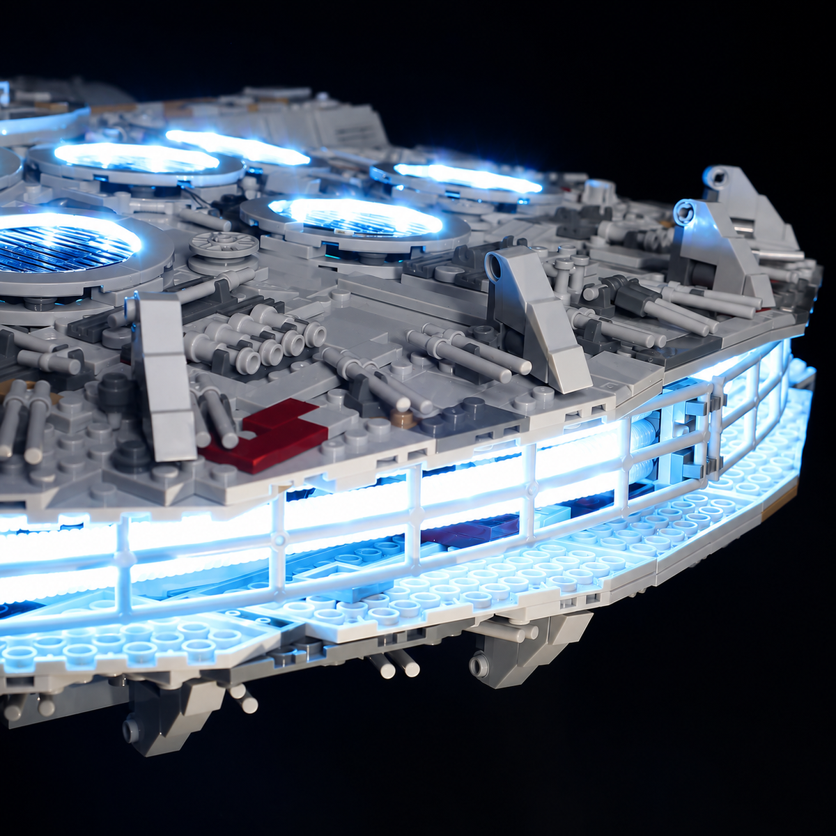Rear hull detail of LEGO Millennium Falcon 75192 showing the illuminated engine strip and blue-lit upper vents.