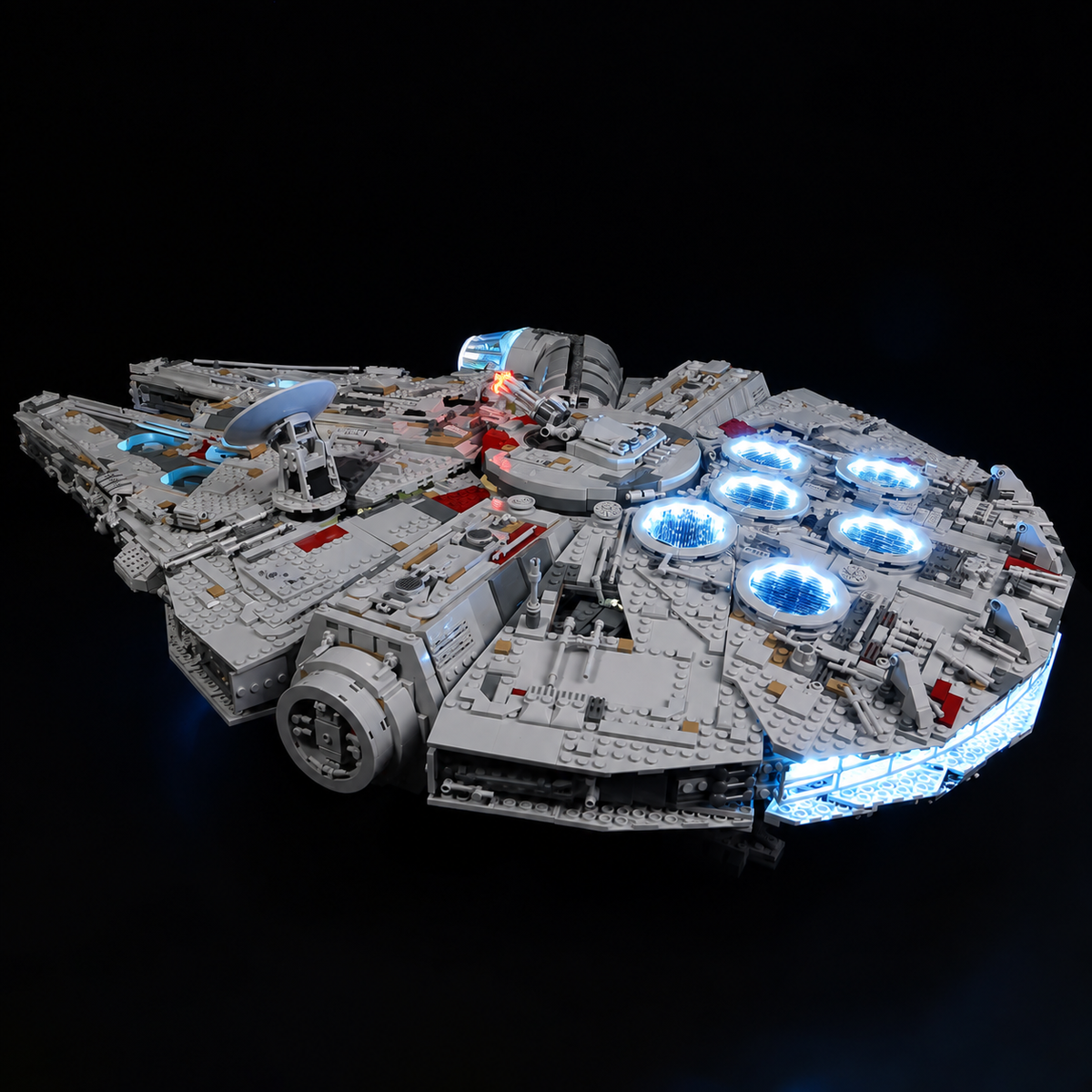 Elevated rear-quarter view of the illuminated LEGO Millennium Falcon 75192 on a black background.