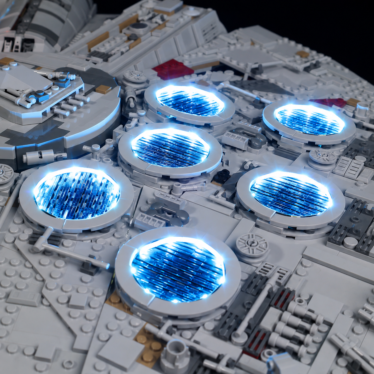 Close-up of six circular engine vents illuminated blue on LEGO Millennium Falcon 75192.