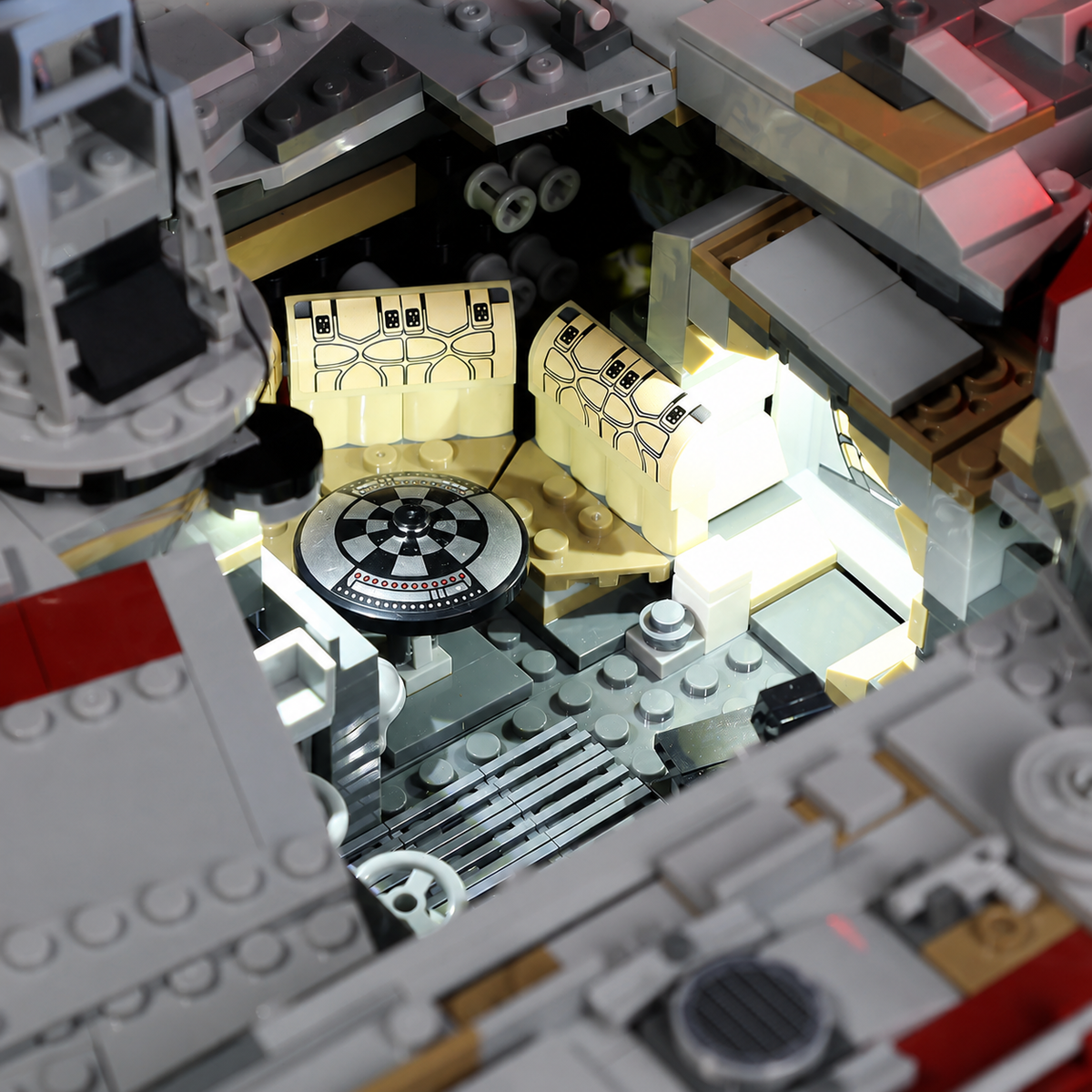 Warm-white lighting inside the LEGO Millennium Falcon 75192 lounge, showing the seating area and game table.
