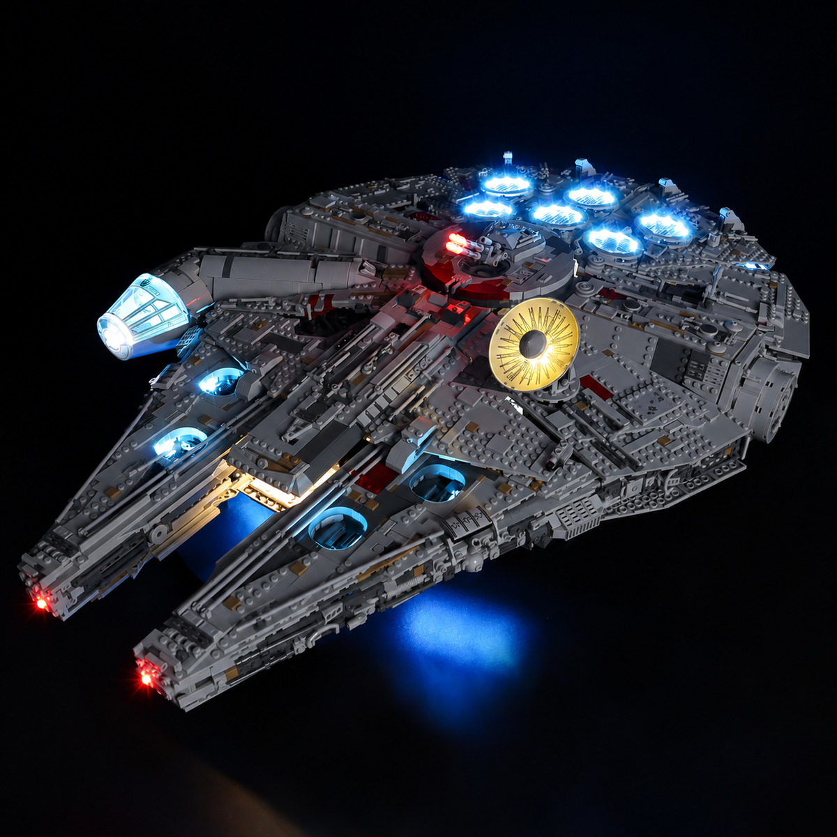 Full front-quarter view of illuminated LEGO Millennium Falcon 75192 with blue vents and cockpit, a warm radar dish and red lights.