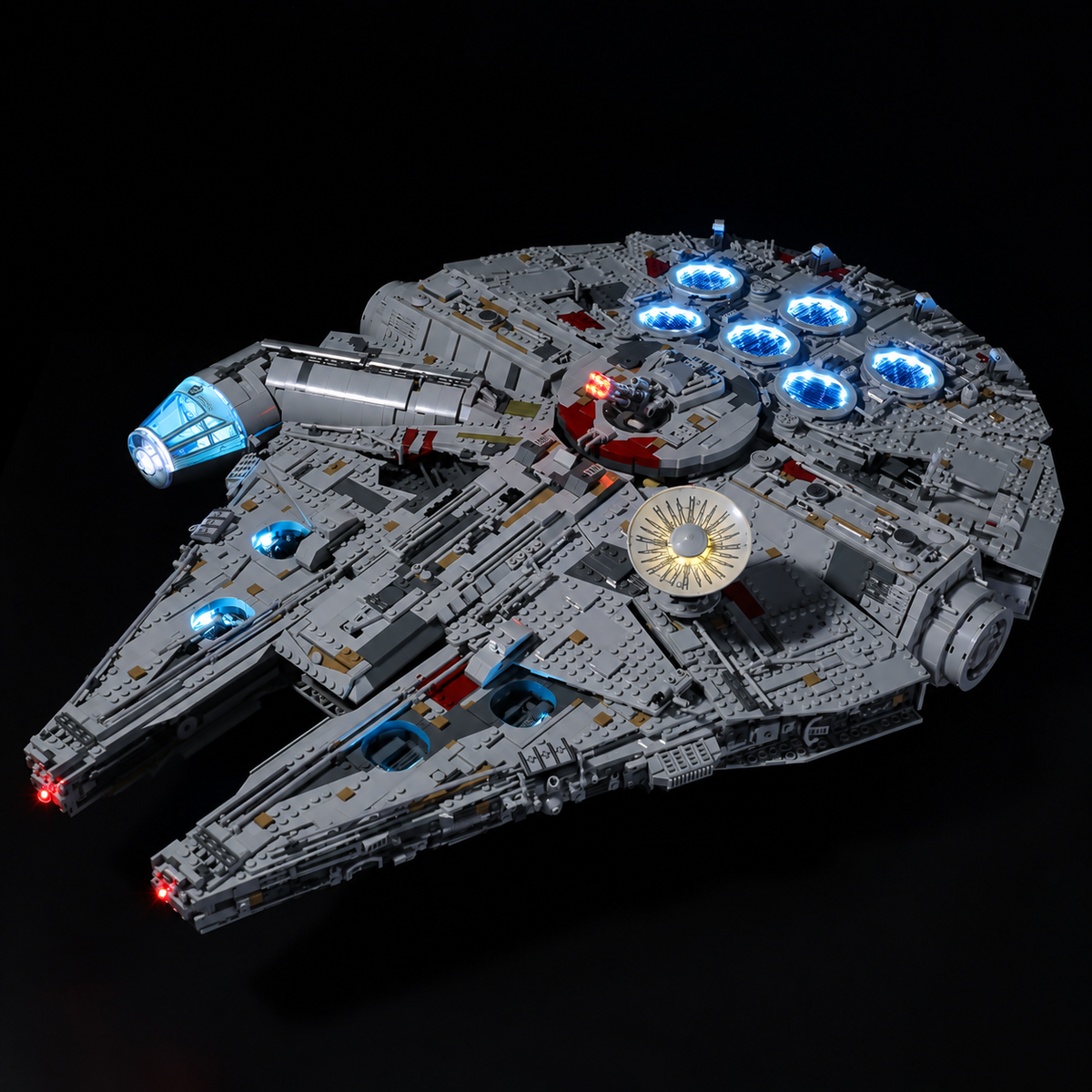 Elevated front-quarter view of LEGO Millennium Falcon 75192 with blue-lit circular vents and cockpit lighting.