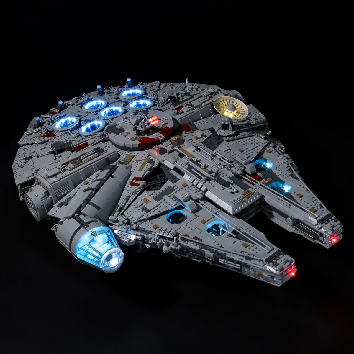 Opposite front-quarter view of LEGO Millennium Falcon 75192 with blue cockpit lighting and warm interior accents.