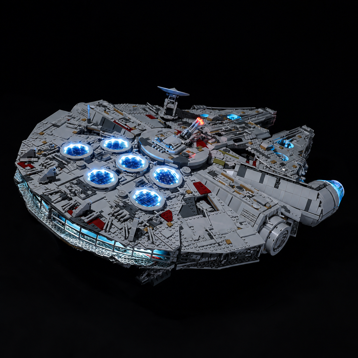 Rear-quarter view of LEGO Millennium Falcon 75192 with blue-lit circular vents and a blue rear engine strip.