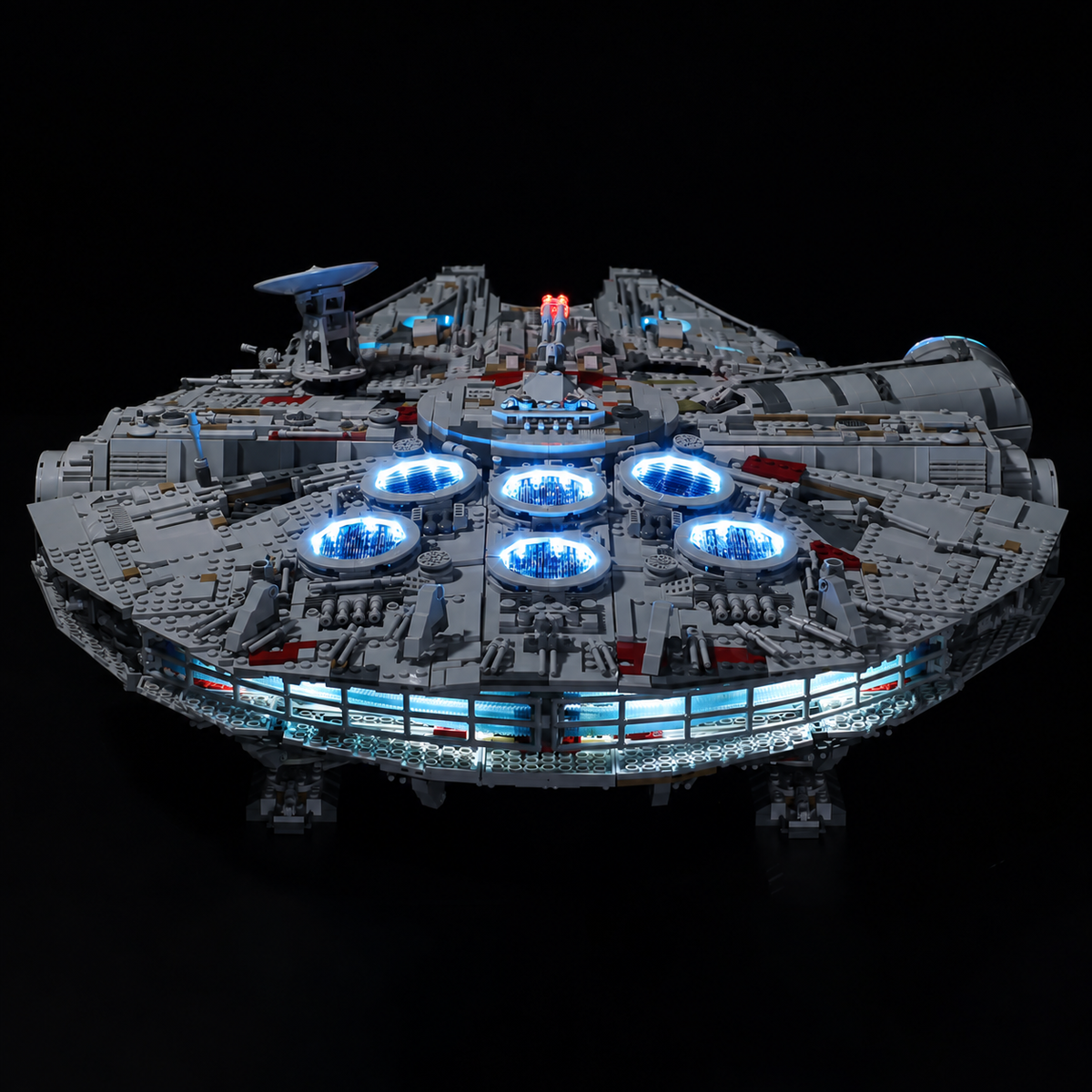 Low rear-quarter view of LEGO Millennium Falcon 75192 showing illuminated engine vents and the rear light strip.