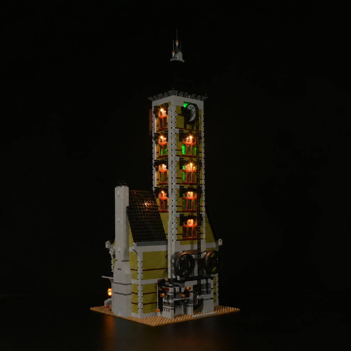 Rear view of LEGO® Haunted House 10273 with Game of Bricks Lights highlighting the tower, shutters and masonry.