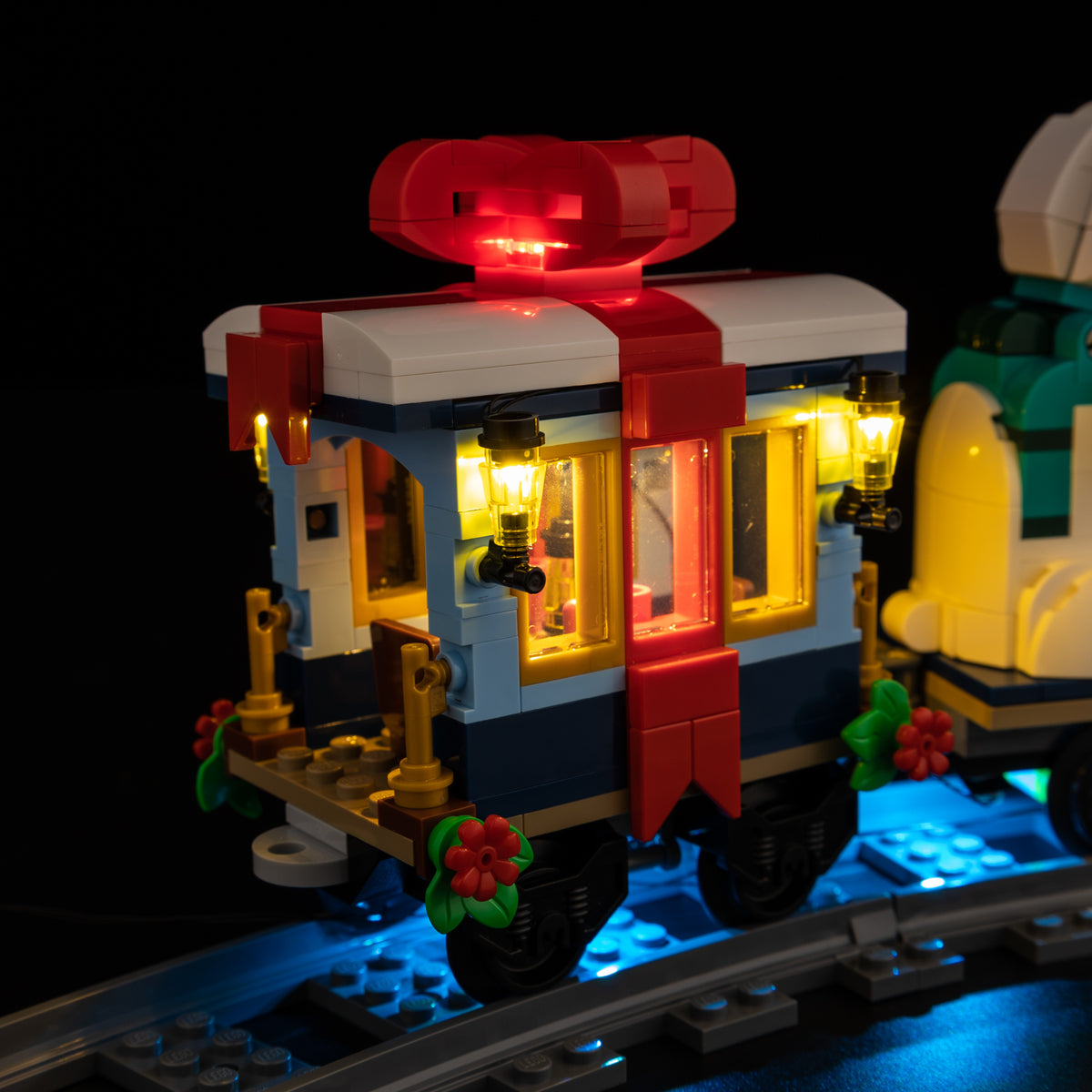 Warm lanterns and a glowing red bow on the gift carriage of LEGO Holiday Express Train 10361