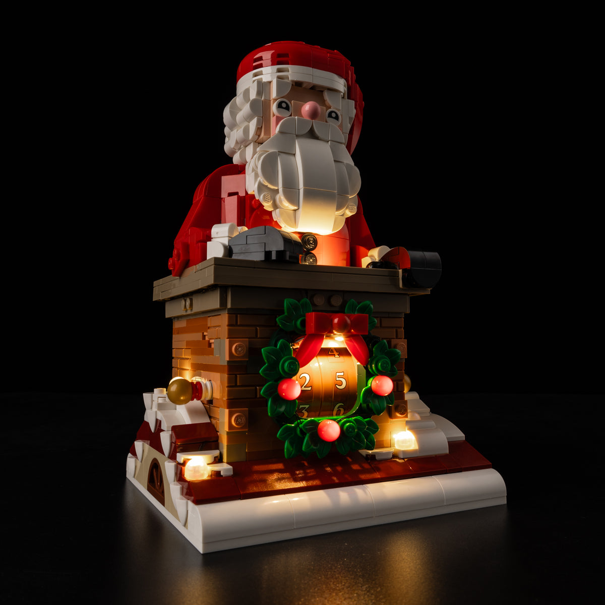 Low product view of LEGO® Santa’s Holiday Countdown 40874 with its real warm lights and red wreath berries.