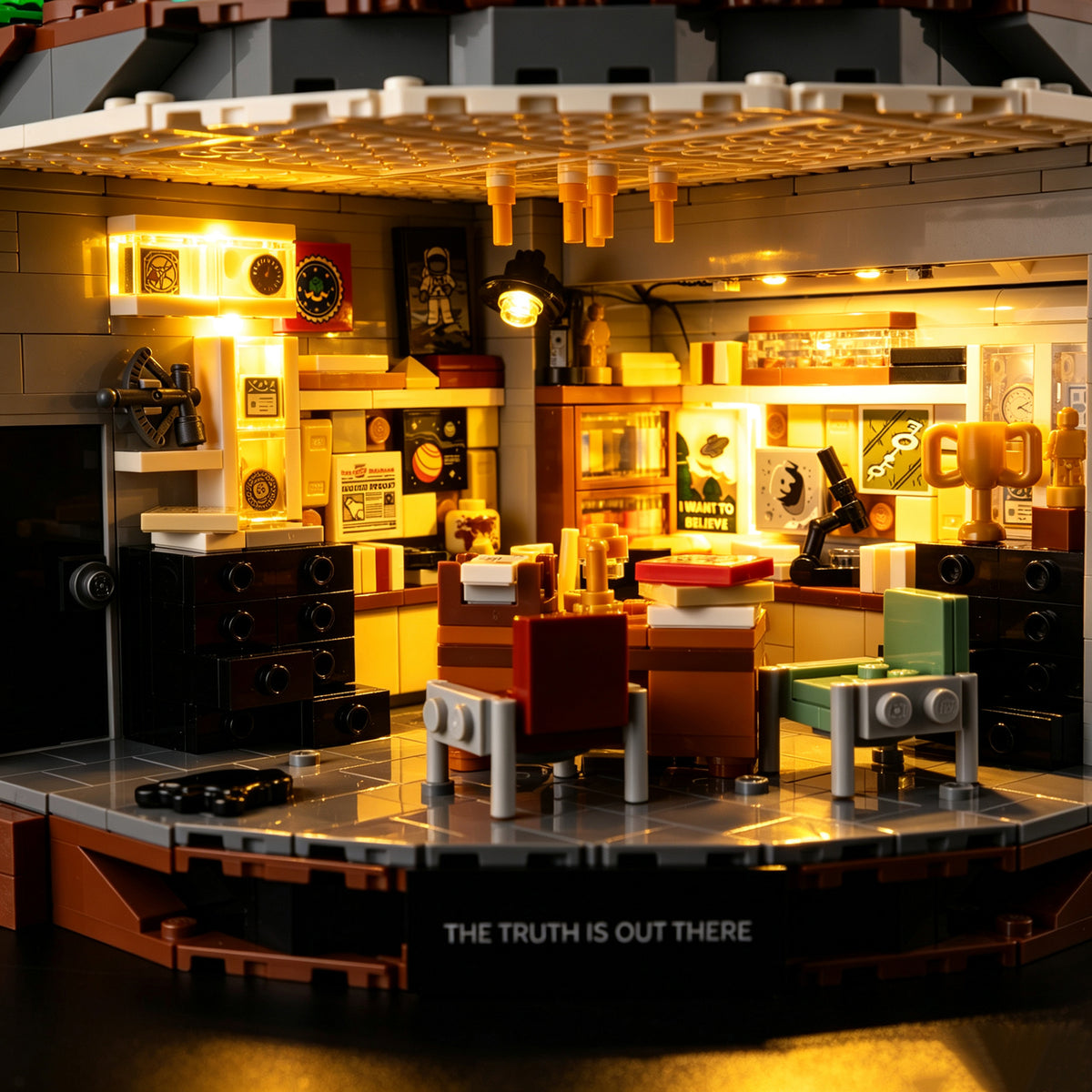 A close view of Mulder’s LEGO office, desk and shelves illuminated by warm Game of Bricks LEDs.