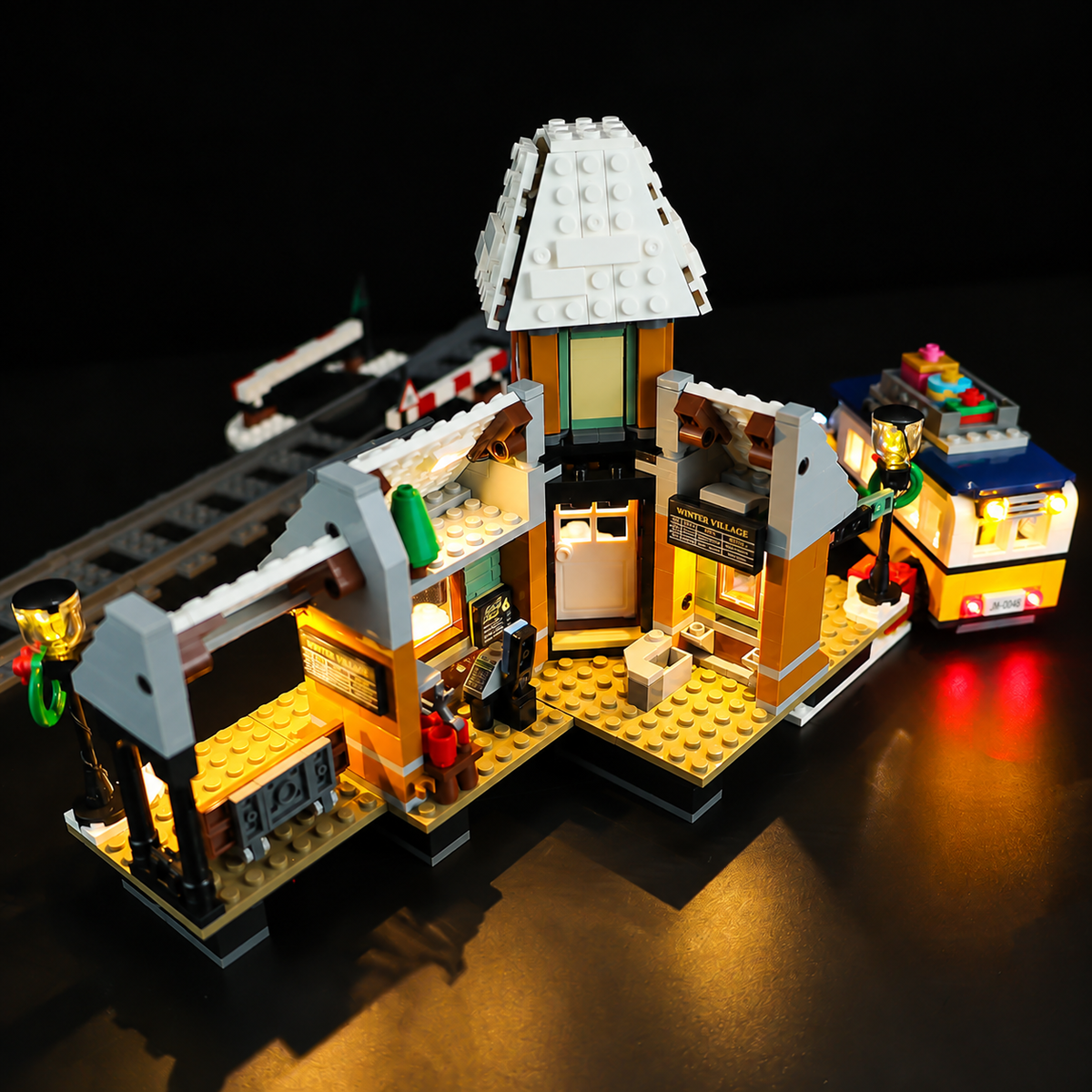 LEGO® Winter Village Station 10259 open-back view showing the lit interior rooms.